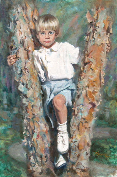 Young boy with blond hair in a white shirt and shorts stands between two tree trunks outdoors.