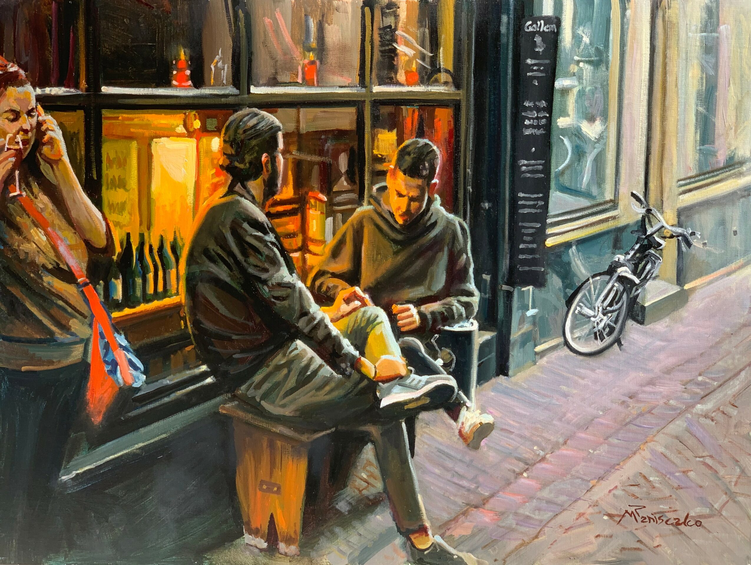 Two young men sit on a bench outside a shop, one reading a book, with a bicycle nearby on the sidewalk.