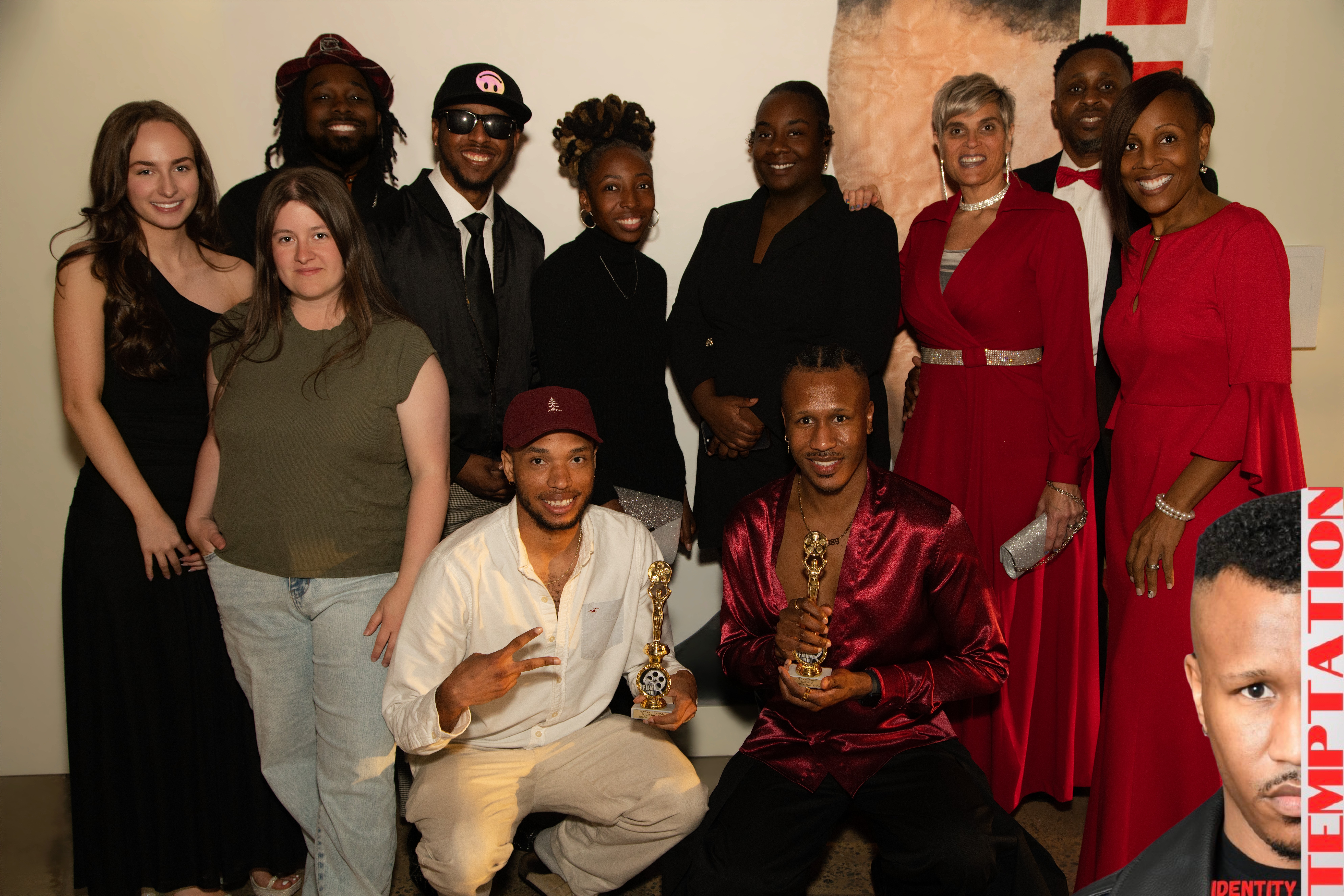 Group of ten diverse people posing indoors, some smiling, some serious, with a plain background.