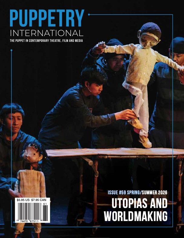 Children and adults perform puppet show on stage with puppets and props, dark background, blue text, and magazine details.