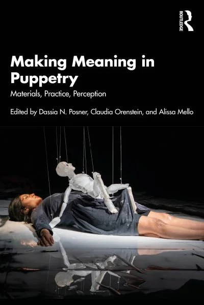 Book cover titled 'Making Meaning in Puppetry' with a person lying on the floor and a puppet above them, suspended by strings.