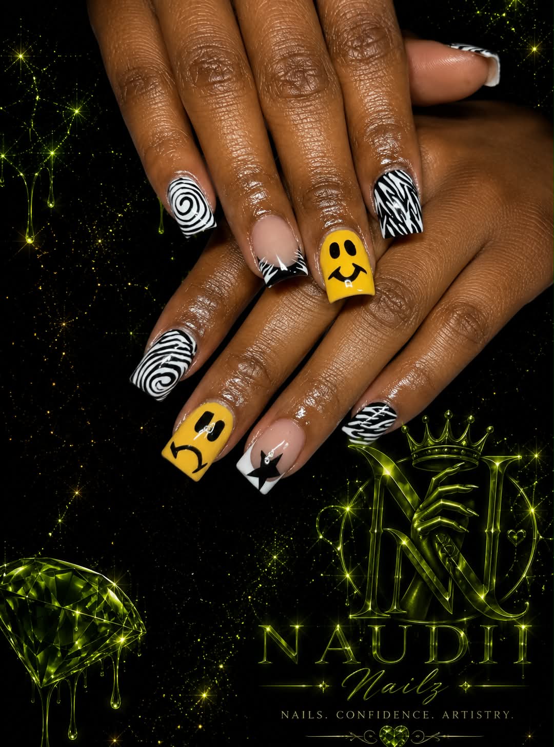 Close-up of hands with black and white patterned and yellow nail art, against a black background with green glowing designs.