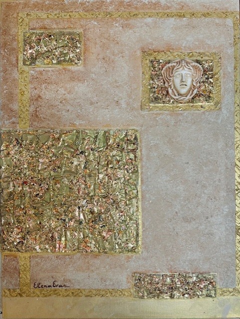Ancient wall with decorative mosaic and a carved face relief, with faded colors and textured surfaces.