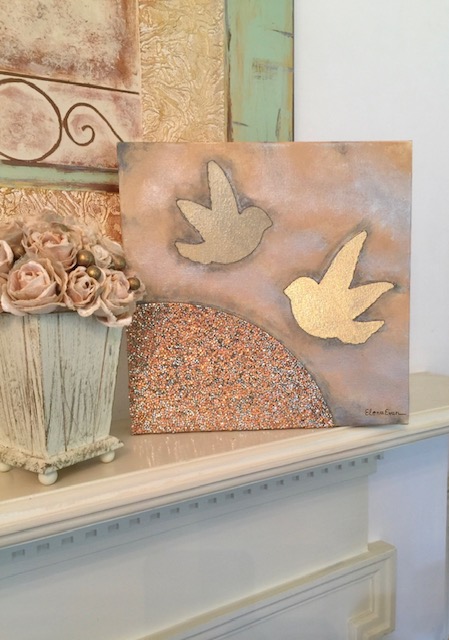 Decorative wall art with two dove shapes, a flower arrangement, and textured elements on a shelf.