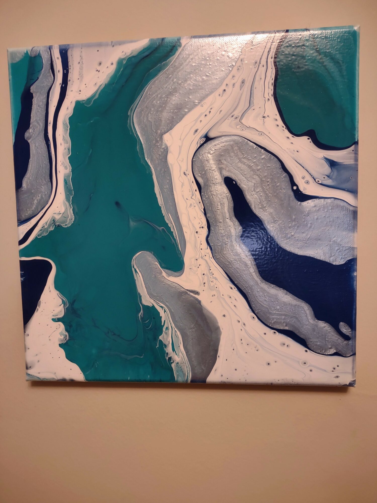 Abstract painting with swirling blue, white, gray, and black colors, resembling marble patterns.