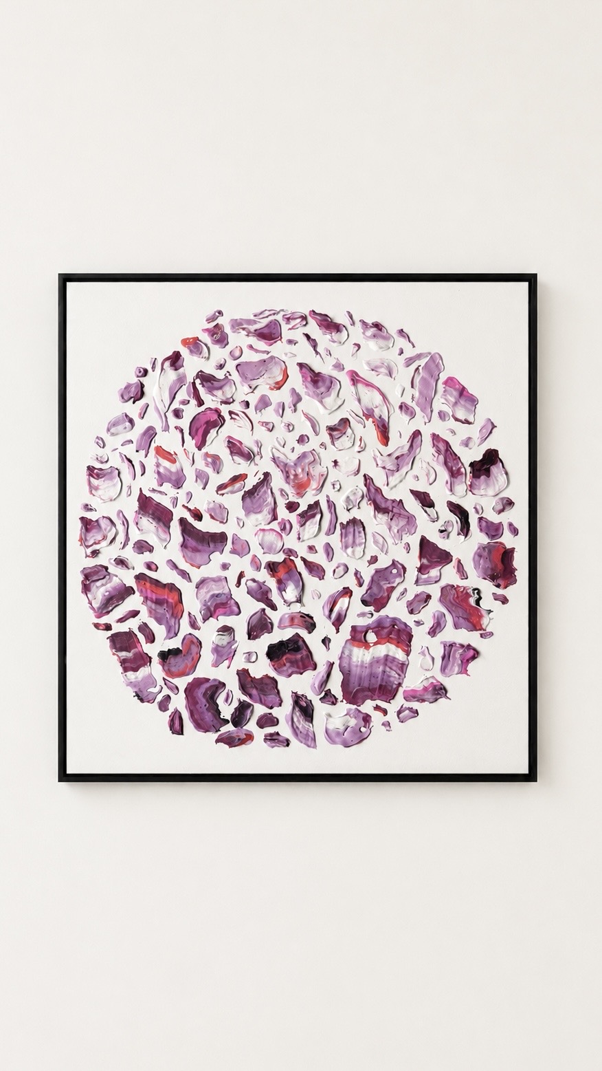 Framed abstract artwork with purple and pink shapes forming a circular pattern on a white background.