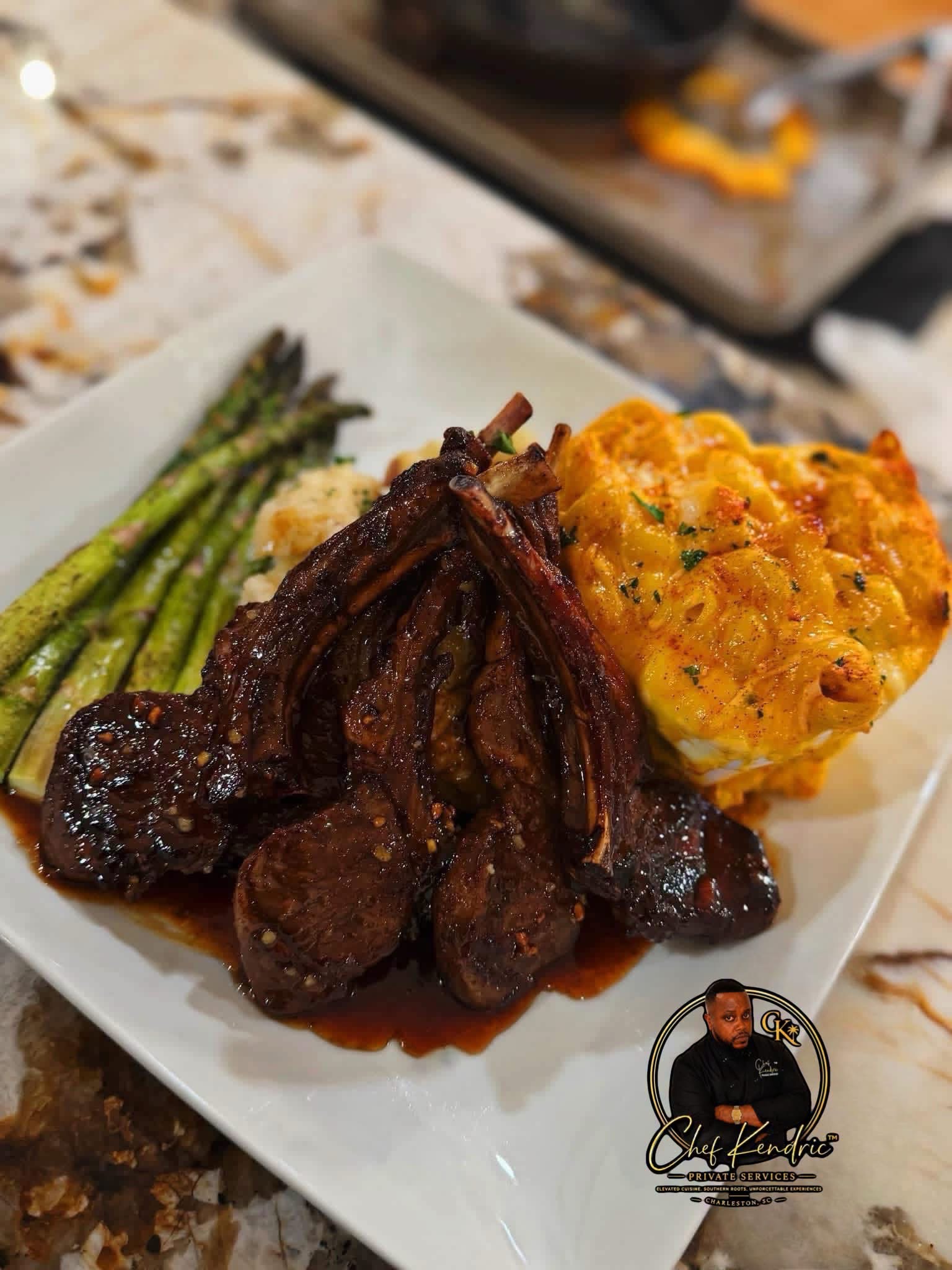 Plate with cooked asparagus, roasted meat, and a baked potato with toppings on a white dish.