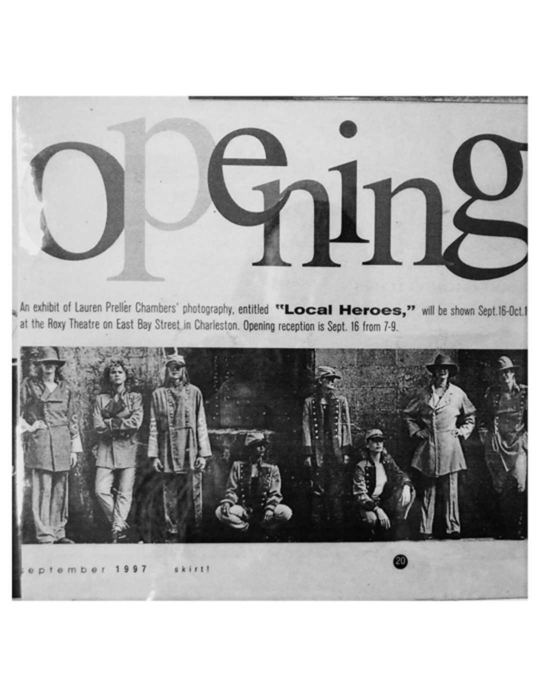 Black and white photo of people standing and sitting, with text about an exhibit opening in September 1987.