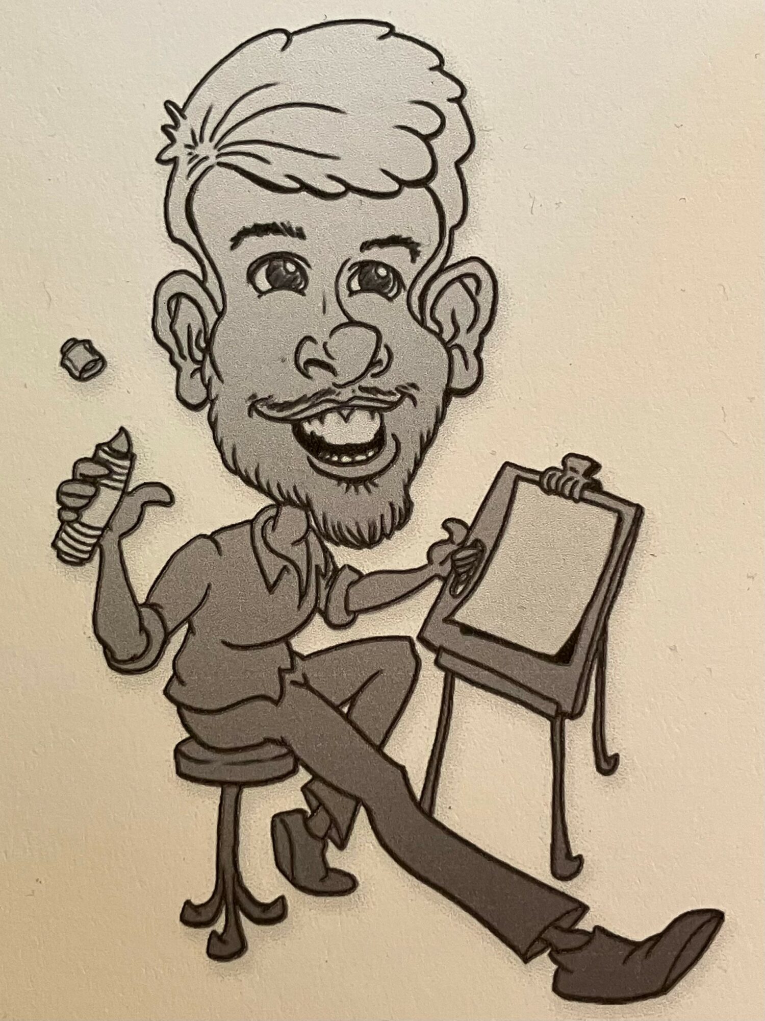 Caricature of a man with a beard, sitting on a stool, holding a pen, with a drawing board in front.