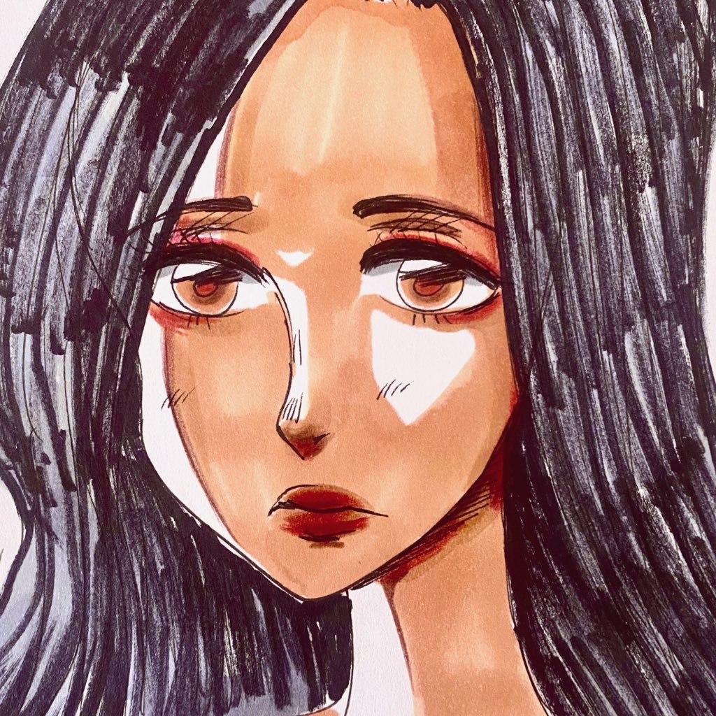 Portrait of a woman with long dark hair and brown eyes, looking directly at the viewer.