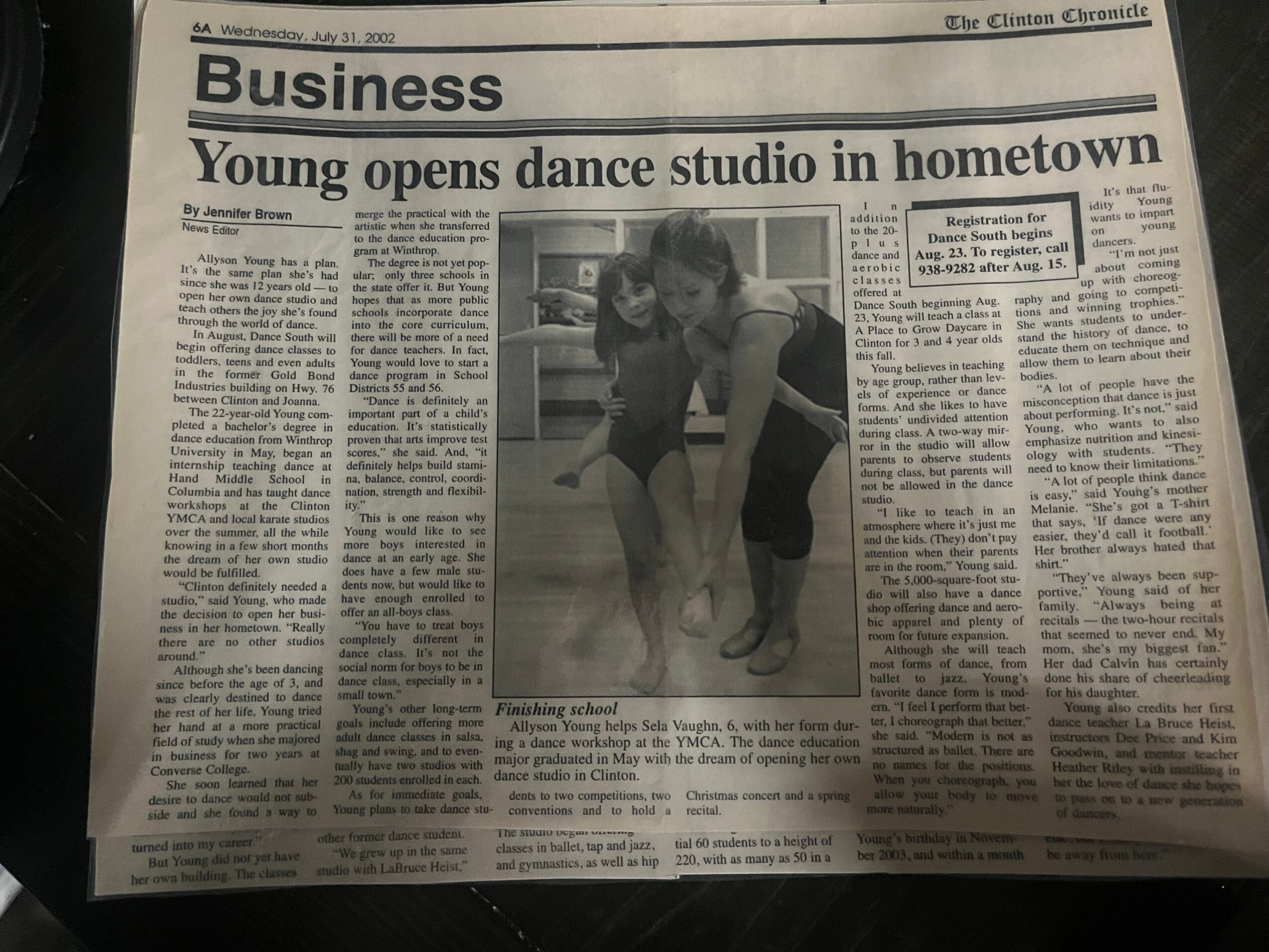 Newspaper page with a headline about a dance studio and a central photo of two people dancing.
