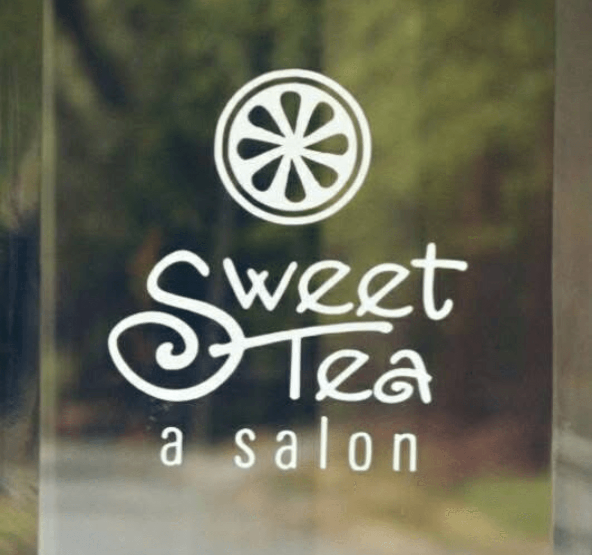 Sign for a salon named Sweet Tea with a lemon slice logo above the text.