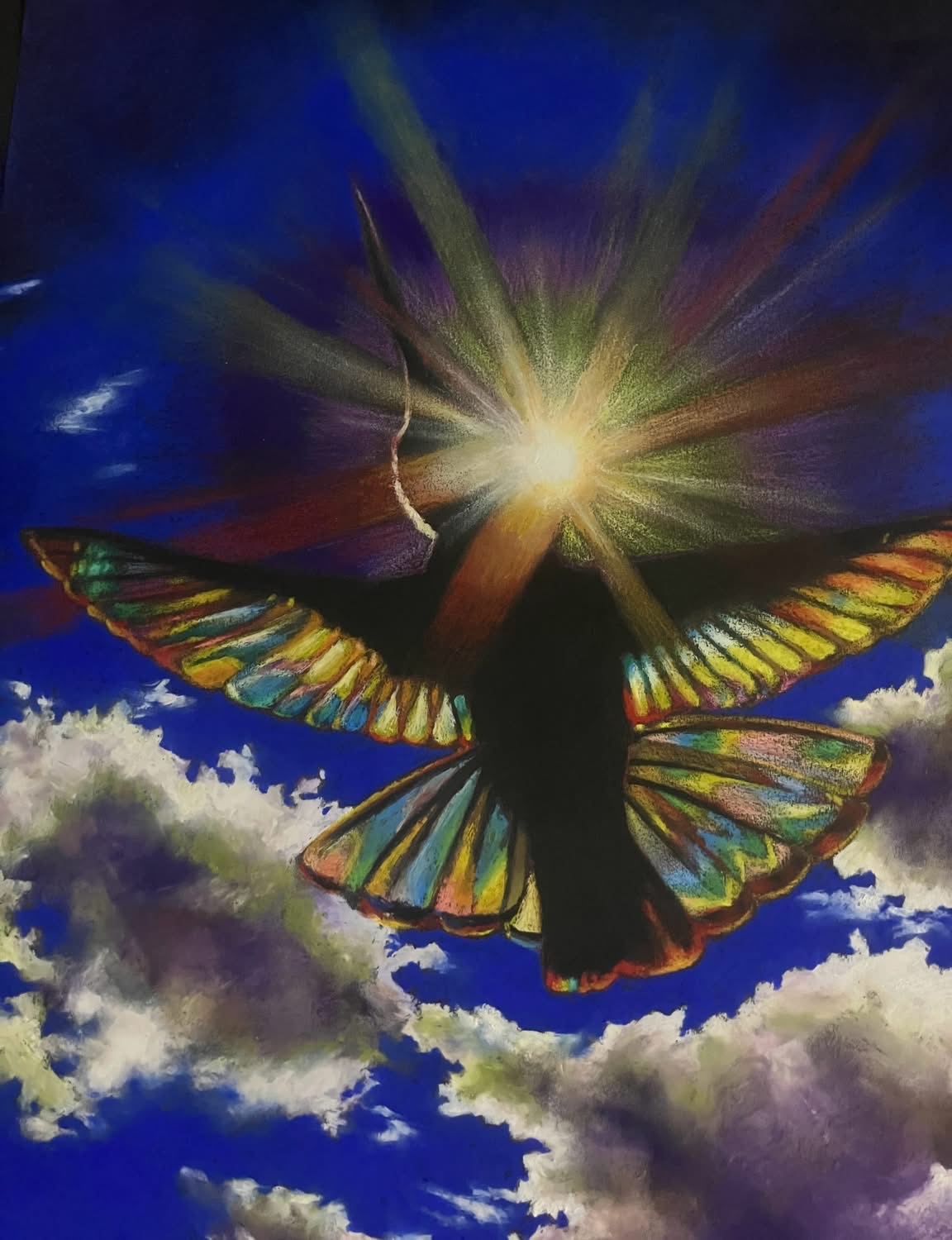 Silhouette of a butterfly with colorful wings flying in front of a bright sun and a blue sky with clouds.