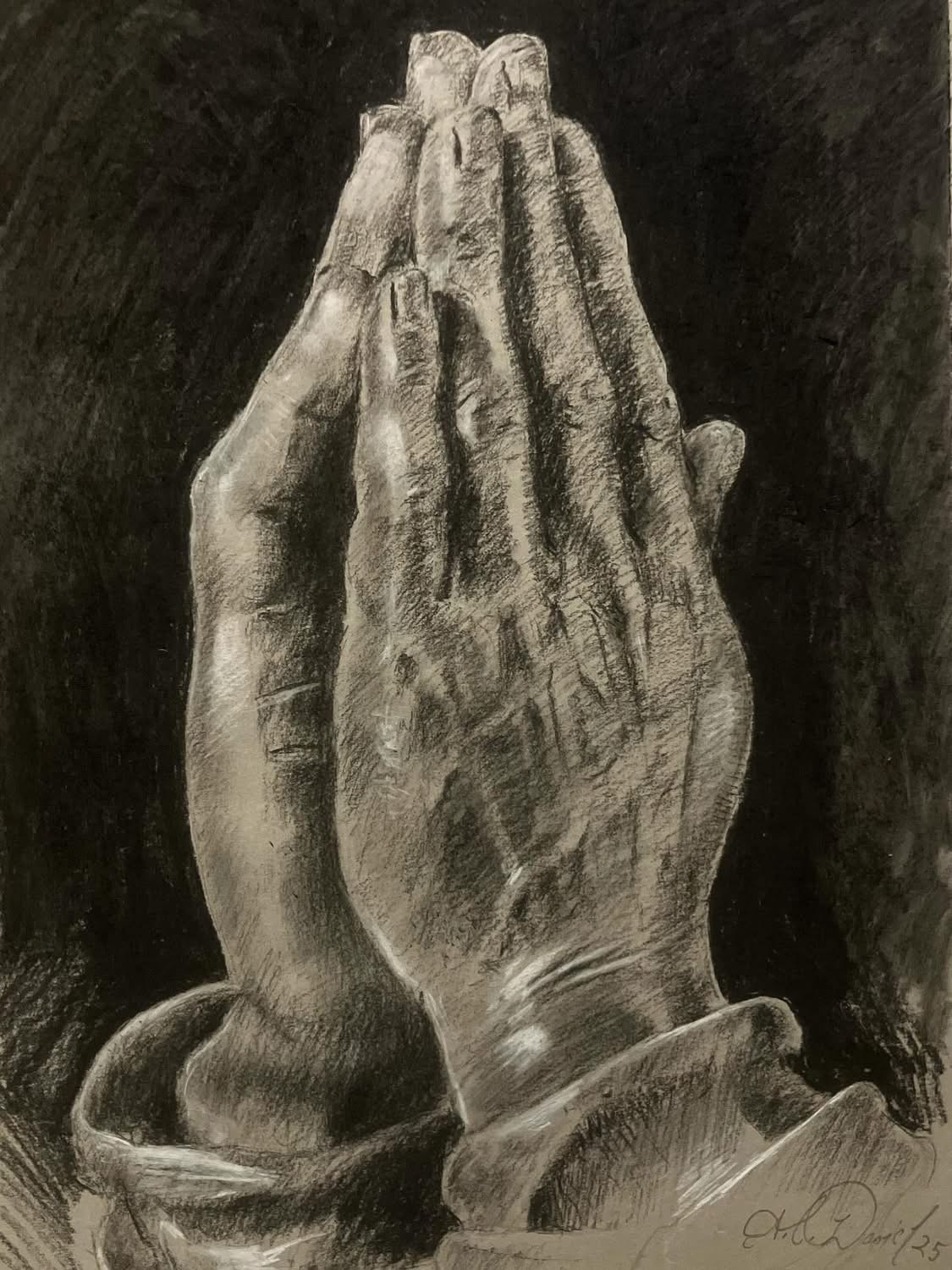 Detailed black and white drawing of two hands pressed together in prayer, with visible fingers and knuckles.
