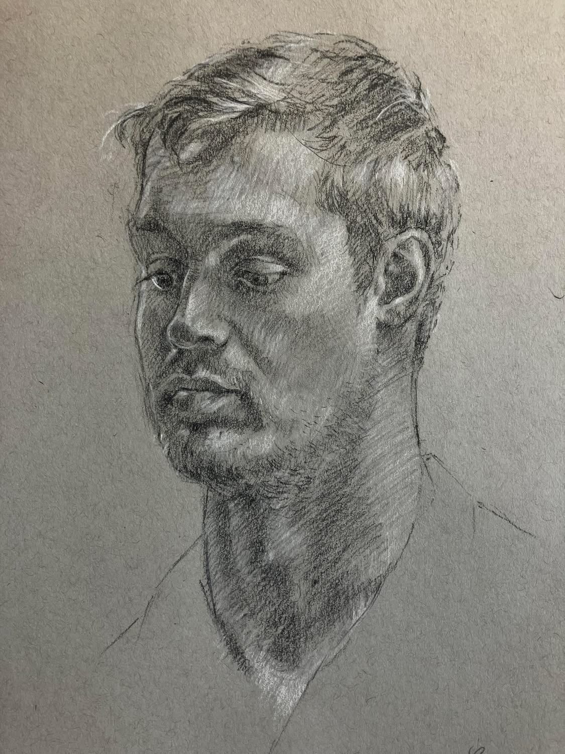 Pencil sketch of a young man with short hair, looking slightly downward, with detailed facial features and a neutral expression.